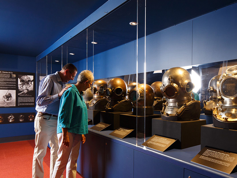 two adults view diving helmet collection 