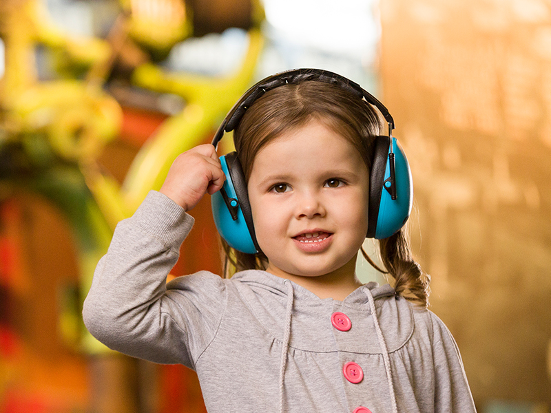a girl wearing sensory friendly headphones 