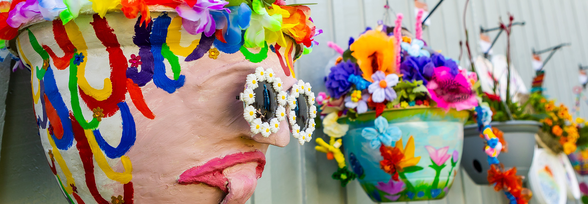 Hanging baskets painted and decorated with floral sunglasses