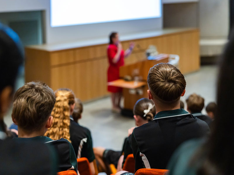 Students watching a presentation in the museum theatre
