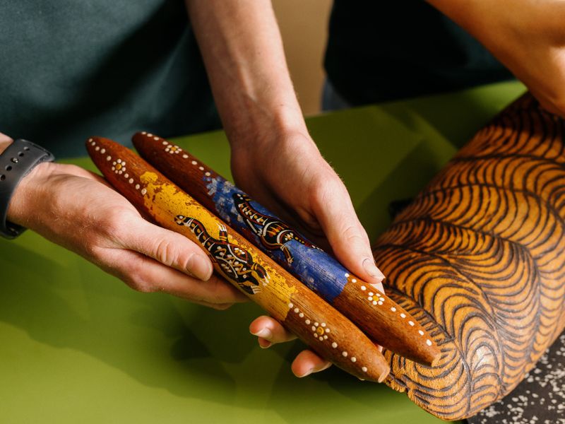 image of person's hands holding First Nations objects