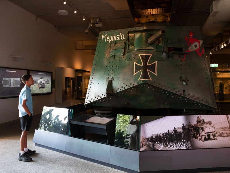 A school student standing in the Anzac Legacy Gallery, looking at the Mephisto tank