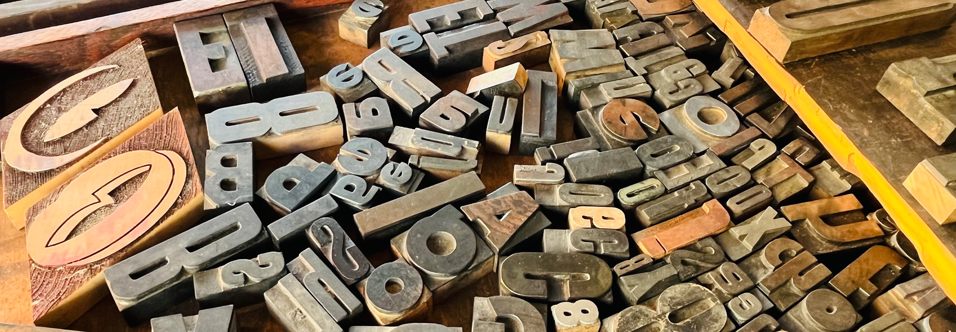 close up photograph of a tray full of letterpress block stamps